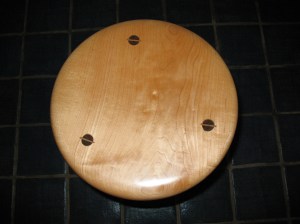 This is a maple stool seat with walnut legs.