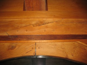 Stopped splayed scarf joint joining two pieces of a 28' beam end to end where they don't meet over a post.  Some of the top stop is covered by a piece of trim.